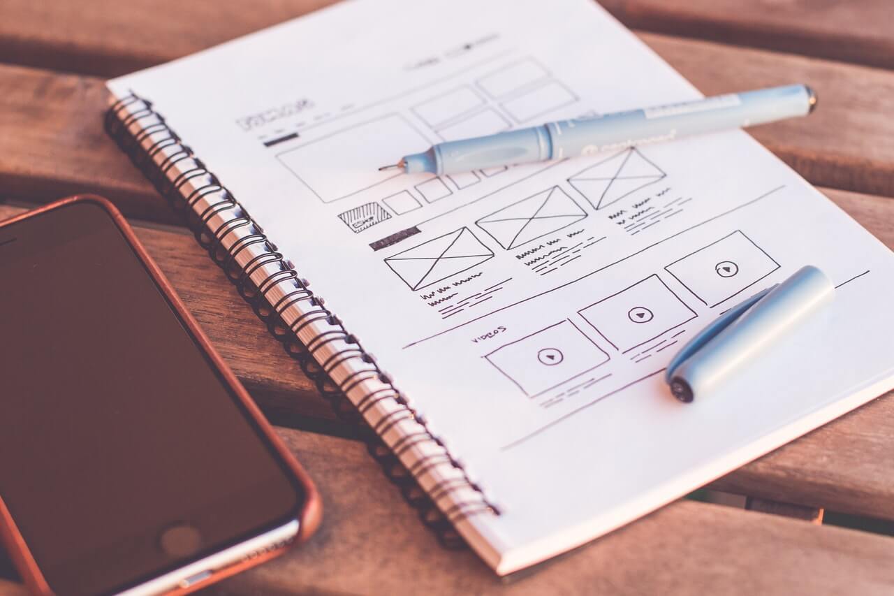 web design wireframes drawn on paper